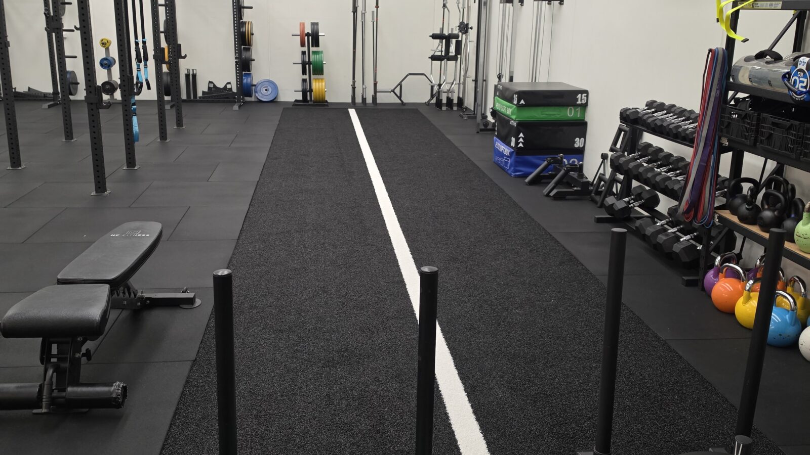 Barbells, kettlebells and plyometric boxes in the Adapt Sports Physiotherapy rehabilitation gym.