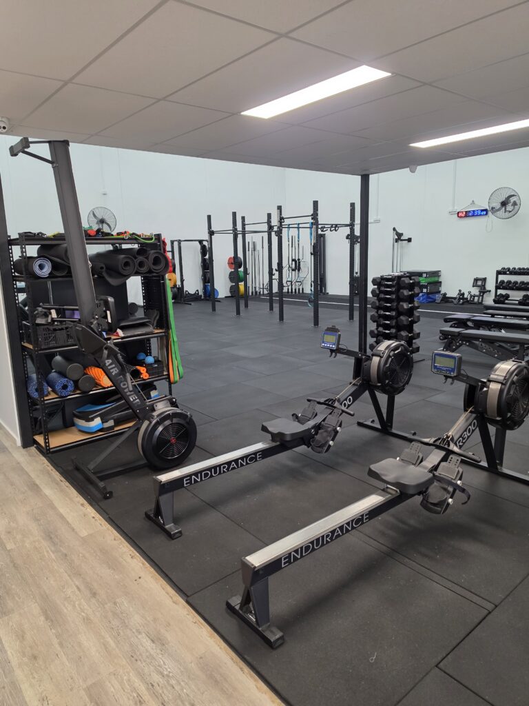 Rowing and cardio equipment in the Adapt Sports Physiotherapy rehabilitation gym.