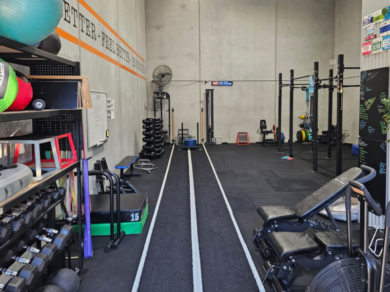 The rehabilitation gym at Adapt Sports Physiotherapy, showing racks, equipment and a marked running lane.