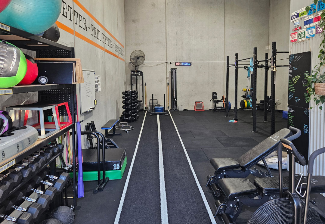 The rehabilitation gym at Adapt Sports Physiotherapy, showing racks, equipment and a marked running lane.
