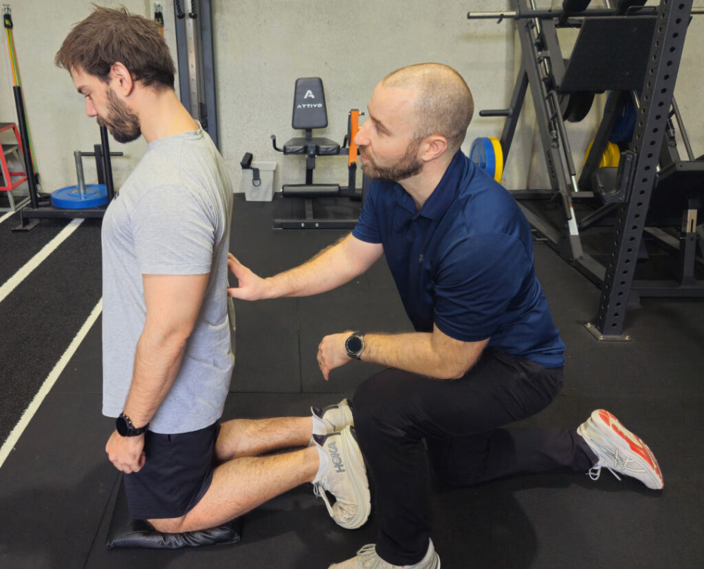 A physiotherapist working with a client in the rehabilitation gym.