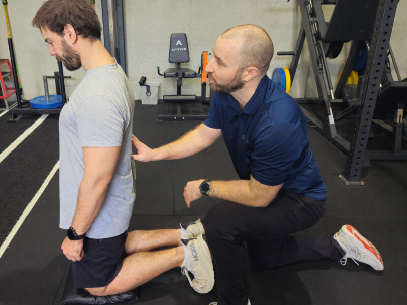 A physiotherapist working with a client in the rehabilitation gym.