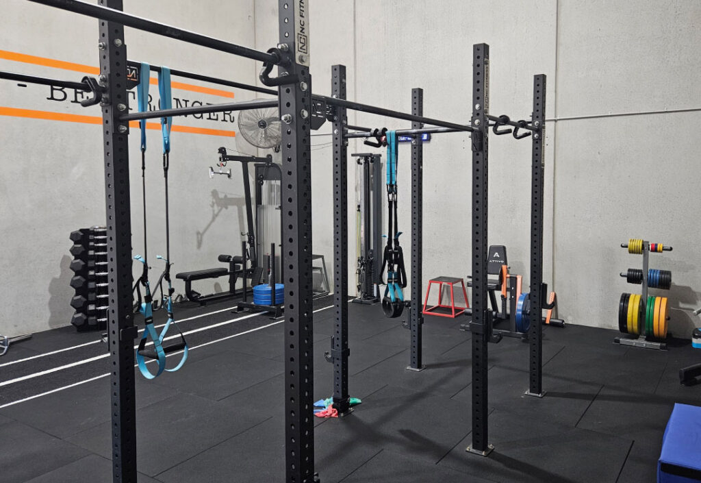 Squat racks and training equipment in the Adapt Sports Physiotherapy rehabilitation gym.