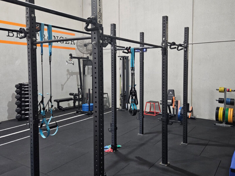 Squat racks and training equipment in the Adapt Sports Physiotherapy rehabilitation gym.